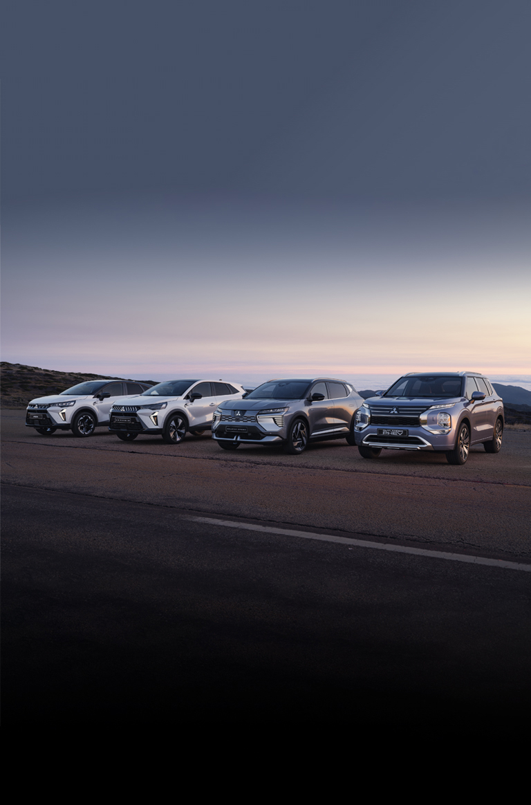 Die Mitsubishi ASX, Grandis, Eclipse Cross und Outlander stehen in der D&auml;mmerung am Stra&szlig;enrand.